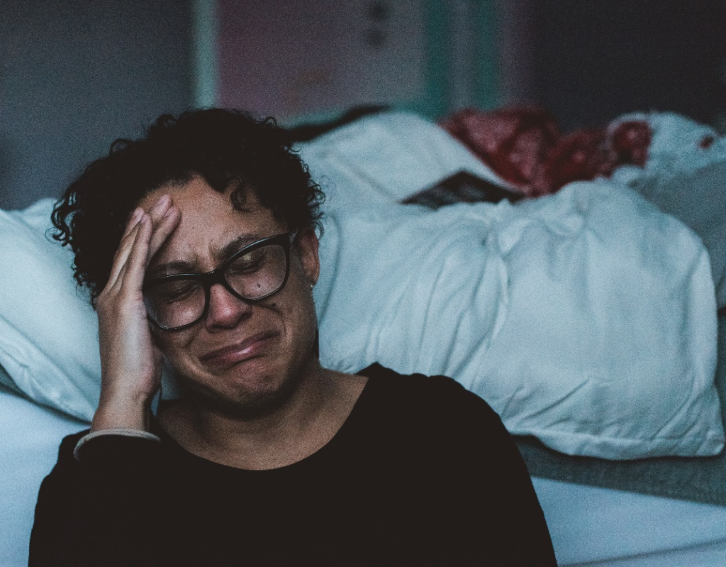 A person crying on the floor