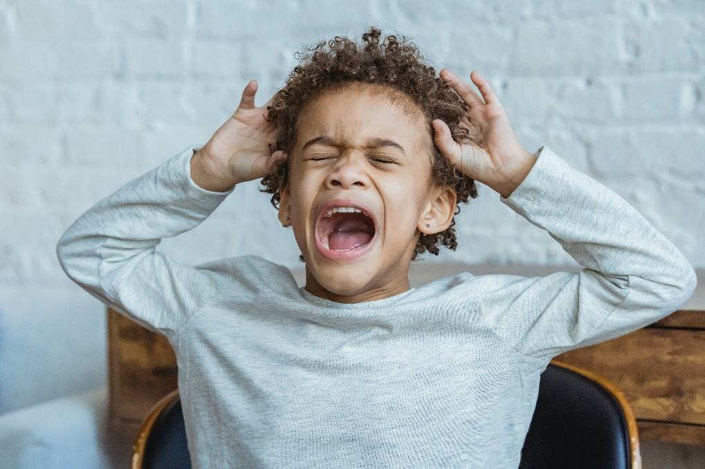 A young boy screaming